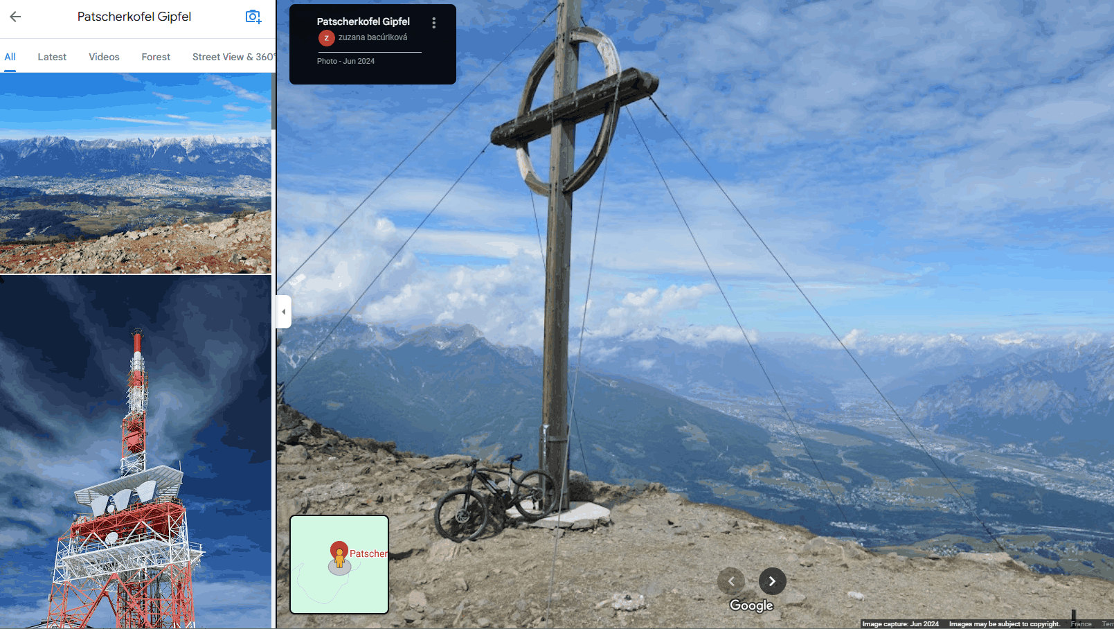 a screenshot of Google Maps showing a summit cross on top of a mountain